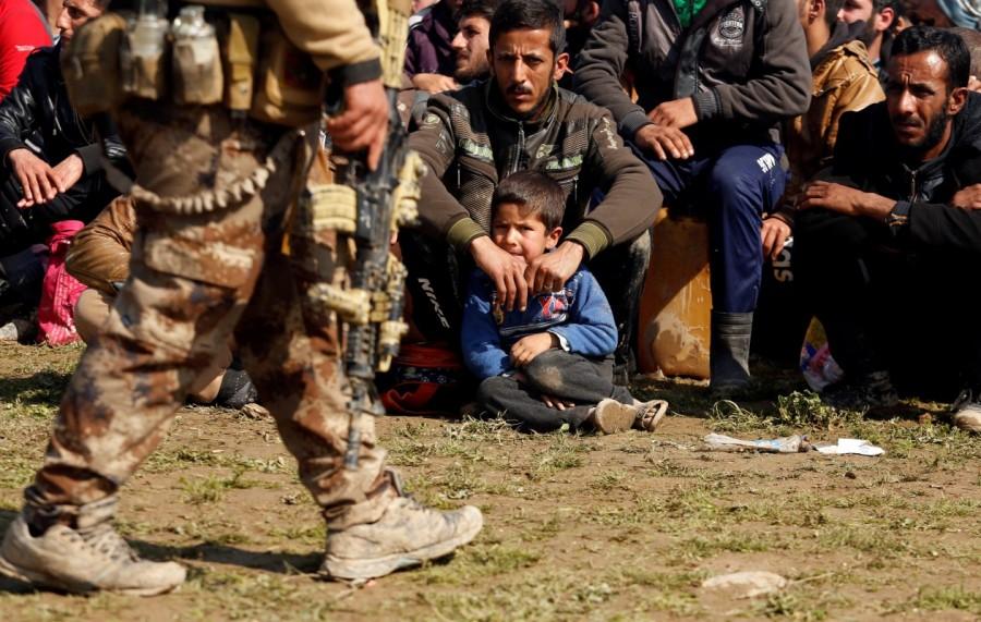 Displaced Iraqis wait for checks by Iraqi forces in western Mosul. Iraqi forces into Mosul,Iraqi forces edge further into Mosul,Mosul,Iraqi forces enter Mosul,Islamic State militants,Islamic militants