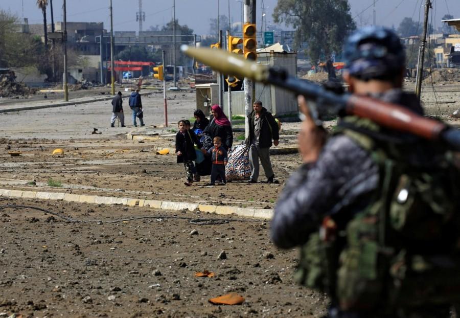 A displaced Iraqi family escape from clashes during a battle between Iraqi forces and Islamic State in Mosul. Iraqi forces into Mosul,Iraqi forces edge further into Mosul,Mosul,Iraqi forces enter Mosul,Islamic State militants,Islamic militants