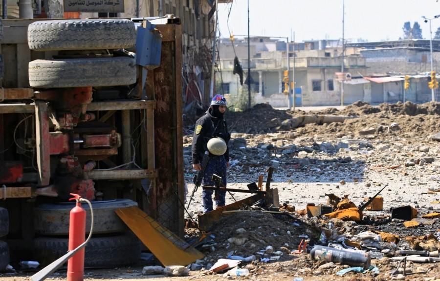 Federal police member carries his weapons near the frontline of the battle between Iraqi forces and Islamic State in Mosul. Iraqi forces into Mosul,Iraqi forces edge further into Mosul,Mosul,Iraqi forces enter Mosul,Islamic State militants,Islamic militants