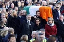 Sinn Fein President Gerry Adams (C) walks next to the coffin of Martin McGuinness during his funeral in Londonderry, Northern Ireland.