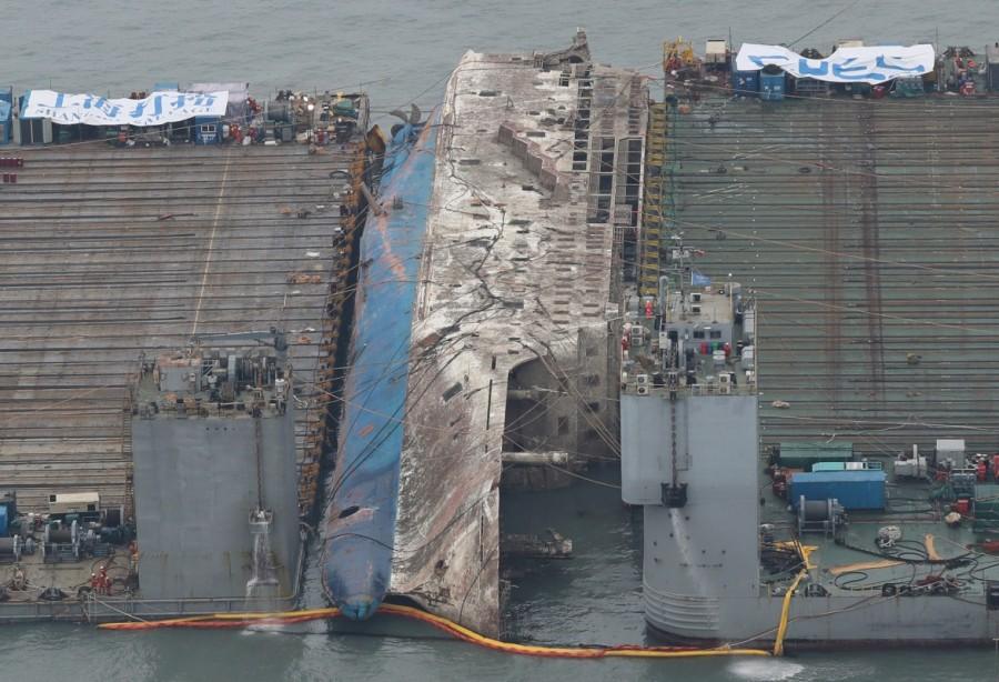 The sunken ferry Sewol is moved toward semi-submersible ship (not pictured) during its salvage operations at the sea off Jindo, South Korea, March 24, 2017. Sunken South Korea,South Korea ferry raised,South Korea ferry,Sewol ferry,Sewol ferry sank,Sewol ferry salvage,sewol ferry disaster