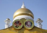 The pictures of Brunei's Prince Abdul Malik and his bride Dayangku Raabi'atul 'Adawiyyah Pengiran Haji Bolkiah are seen in front of the Sultan Omar Ali Saifuddien mosque in Bandar Seri Begawan.