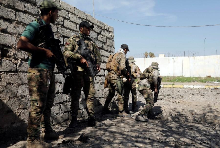 Iraqi rapid response members prepare to cross a route to avoid being hit by Islamic State snipers in western Mosul. Sniper wars,Mosul sniper wars,Islamic State,Islamic State mounts,Iraqi forces