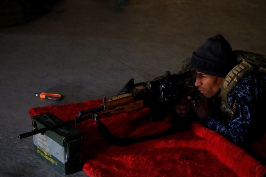 A sniper of the Iraqi Federal Police takes his position at a destroyed builiding near Islamic State fighters' positions at Bab al Jadid district in the old city of Mosul. Sniper wars,Mosul sniper wars,Islamic State,Islamic State mounts,Iraqi forces