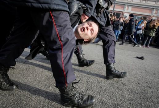 Law enforcement officers detains an opposition supporter during a rally in Moscow.