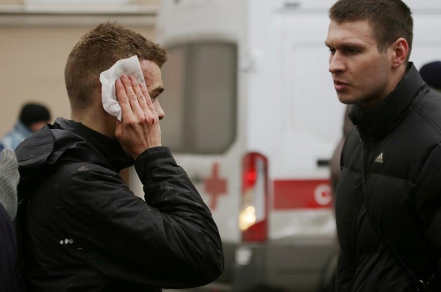 An injured person stands outside Sennaya Ploshchad metro station, following explosions in two train carriages at metro stations in St. Petersburg, Russia. St Petersburg,St Petersburg blast,St Petersburg metro railway blasts,St Petersburg explosions,Russia St Petersburg train blasts injured,metro blast,Russian city of St Petersburg