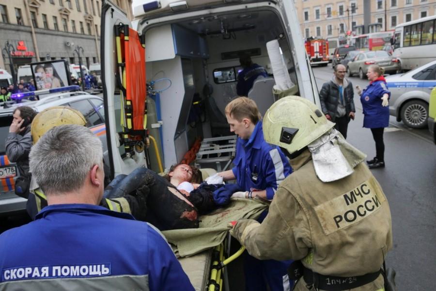 An injured person is helped by emergency services outside Sennaya Ploshchad metro station, following explosions in two train carriages at metro stations in St. Petersburg, Russia April 3, 2017. St Petersburg,St Petersburg blast,St Petersburg metro railway blasts,St Petersburg explosions,Russia St Petersburg train blasts injured,metro blast,Russian city of St Petersburg