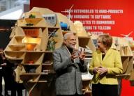 Narendra Modi and Angela Markel near 'Make in India' installation.