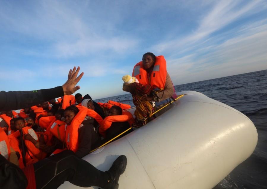 A rescuer tries to find his balance before taking a four-day-old baby girl into a RHIB, during a search and rescue operation by Spanish NGO Proactiva Open Arms. The baby was traveling on one of two rubber boats carrying over 200 migrants from North and Central Africa, Sri Lanka and Yemen and seen drifting some 22 nautical miles north of the Libyan town of Sabratha, the most frequently used departure point currently used by people smugglers in Libya. Mediterranean,Mediterranean sea,480 migrants rescued,Baby migrants,migrants