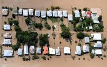 Houses are surrounded by floodwaters brought on by Cyclone Debbie at Depot Hill in Rockhampton.