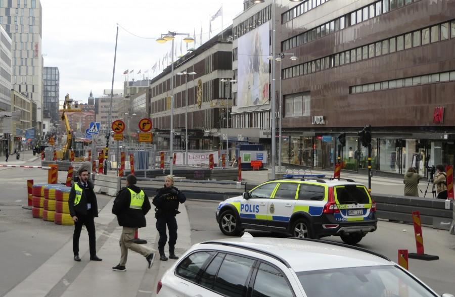 Police officers guard in downtown Stockholm, Sweden, April 7, 2017. Truck drives,Sweden,shopping street,Stockholm,Truck drives into crowd in Sweden,Truck drives into crowd