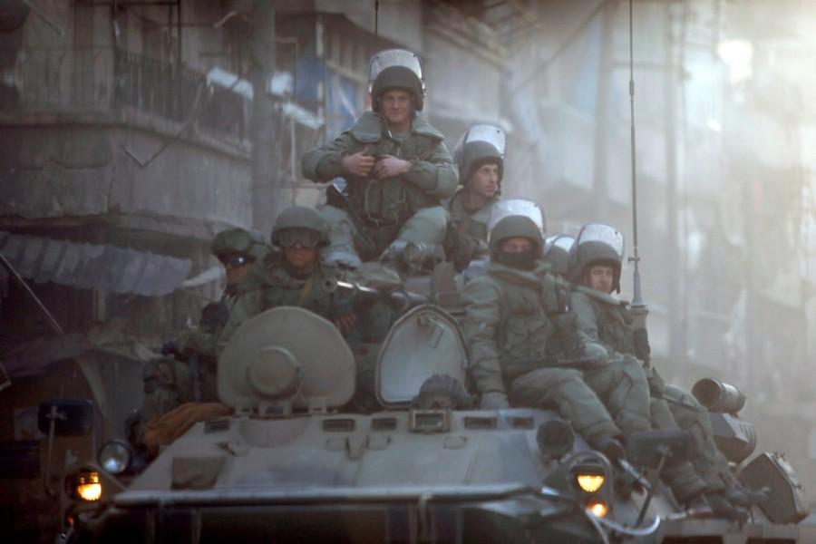 Russian soldiers, on armored vehicles, patrol a street in Aleppo, February 2017. Russian forces in Syria,Russian forces,Syria,war on Assad,Russia,Syrian government