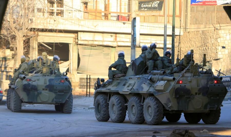 Russian soldiers, on armoured vehicles, patrol a street in Aleppo, February 2017. Russian forces in Syria,Russian forces,Syria,war on Assad,Russia,Syrian government