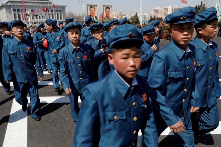 Men wearing uniforms check a newly constructed residential complex after its opening ceremony in Ryomyong street in Pyongyang, North Korea. North Korea,Pyongyang,Postcards from Pyongyang,Kim Il-sung,father Kim Il-sung