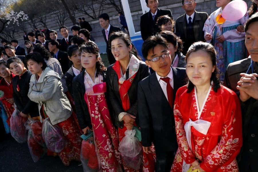 People react as a vehicle carrying foreign reporters passes. North Korea,Pyongyang,Postcards from Pyongyang,Kim Il-sung,father Kim Il-sung