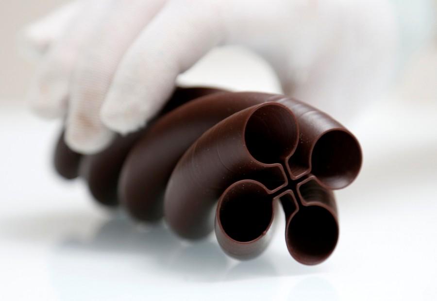 Gaetan Richard, founder of the Miam Factory 3D printing chocolate company, displays a three-dimensional shape object after being printed at Belgian chocolate company Miam Factory in Gembloux. Chocolate printed in 3D,Chocolate 3D,printed in 3D,Beer bottles,Belgian chocolate company,Miam Factory