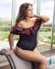 Pregnant Binky Felstead poses in a swimming costume.