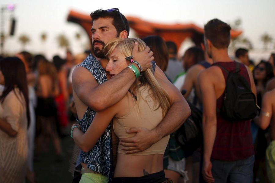 A couple listens to Hozier at the Coachella Valley Music and Arts Festival in Indio, California April 11, 2015. Coachella 2017,Coachella,Coachella festival,Coachella festival 2017,The Music and Arts Festival,Coachella 2017 pics,Coachella 2017 images,Coachella 2017 stills,Coachella 2017 pictures,Coachella 2017 phoots