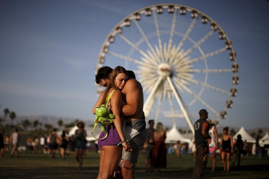 A couple hugs in front of the ferris wheel at the Coachella Valley Music and Arts Festival in Indio, California April 10, 2015. Coachella 2017,Coachella,Coachella festival,Coachella festival 2017,The Music and Arts Festival,Coachella 2017 pics,Coachella 2017 images,Coachella 2017 stills,Coachella 2017 pictures,Coachella 2017 phoots