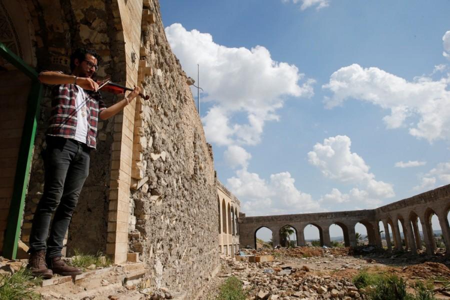 Mukdad, 28, fled Mosul after Islamic State fighters stormed his house and confiscated his instruments, deeming his music a violation of their hardline interpretation of Sunni Islam. Wednesday's hour-long concert marked his first return to the city that was overrun by Islamic State in 2014. Iraqi violinist,violinist,Mosul after ISIS,Iraqi violinist returns to play Mosul,Muslims and Christians in Mosul,Ameen Mukdad,Islamic State militants,Islamic State