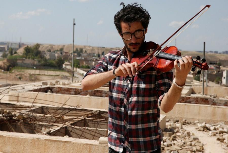 Mukdad said he chose the Tomb of Jonas, or Mosque of the Prophet Younis, as the site is known by Muslims, to symbolize unity. "I want to take the opportunity to send a message to the world and send a strike against terrorism and all ideologies which restrict freedom that music is a beautiful thing," he said. "Everyone who opposes music is ugly." Iraqi violinist,violinist,Mosul after ISIS,Iraqi violinist returns to play Mosul,Muslims and Christians in Mosul,Ameen Mukdad,Islamic State militants,Islamic State
