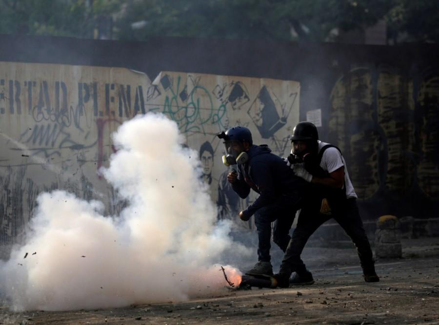 Opposition demonstrators fire a homemade mortar towards the riot police during the so-called "mother of all marches" against Venezuela's President Nicolas Maduro, in Caracas, Venezuela, April 19, 2017. Mother of all marches,Venezuela,President Nicolas Maduro,Nicolas Maduro,violent demonstrations,demonstrations