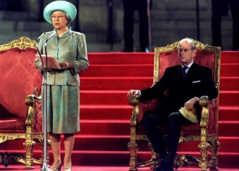 Queen Elizabeth II delivers an address to both houses of parliament at the Palace of Westminster May 5 watched by Prince Philip (R).