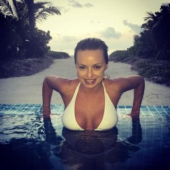 Ola Jordan shows cleavage in white bikini.