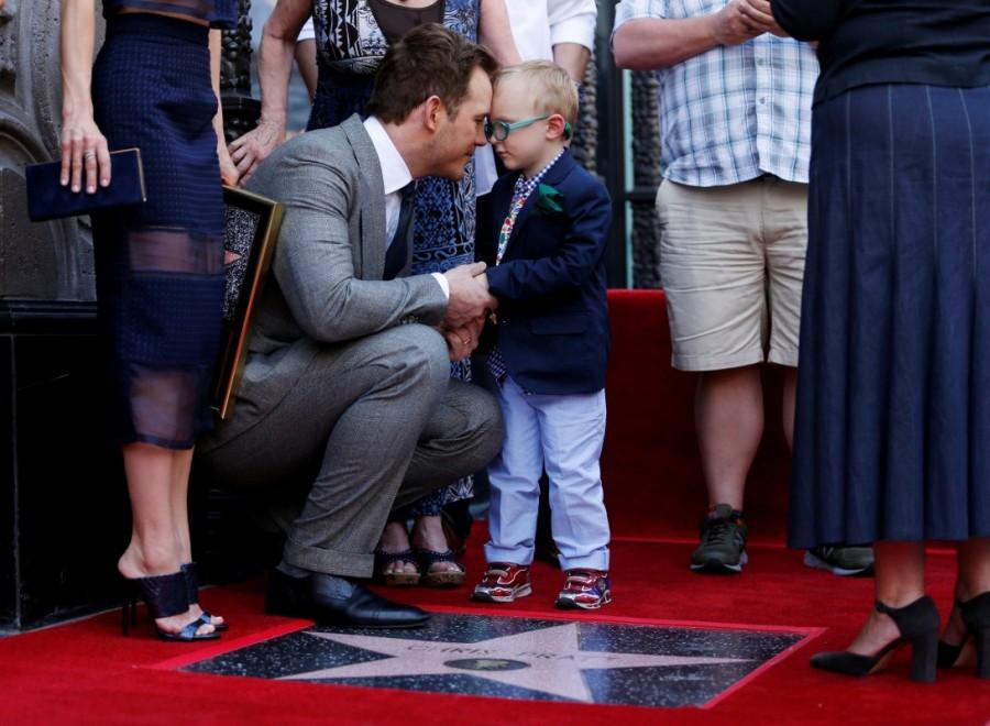 Actor Chris Pratt shares a moment with his four-year old son Jack Pratt while his wife Anna Faris (L) holds a plaque next to them in Hollywood, California. Chris Pratt,Chris Pratt gets Hollywood Walk of Fame,Hollywood Walk of Fame,Chris Pratt Walk of Fame,Chris Pratt pics,Chris Pratt images,Chris Pratt stills,Chris Pratt pictures,Chris Pratt photos
