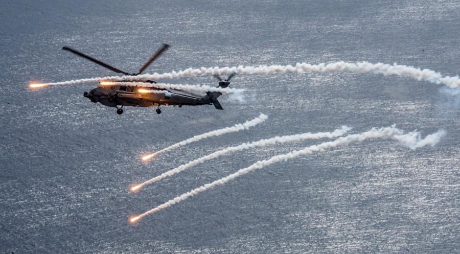A U.S. Navy MH-60R Sea Hawk helicopter from the "Blue Hawks" of Helicopter Maritime Strike Squadron 78 fires chaff flares during a training exercise near the aircraft carrier USS Carl Vinson (CVN 70) in the Philippine Sea April 24, 2017. A North Korean official speaking on CNN said the country would not be influenced by outside events. "As long as America continues its hostile acts of aggression, we will never stop nuclear and missile tests," said Sok Chol Won, director of the North's Institute of Human Rights at the Academy of Social Sciences. USS Carl Vinson,Carl Vinson,USS Carl Vinson on patrol,USS Carl Vinson aircraft,Korean waters,USS Michigan,North Korean,North Korean nuclear