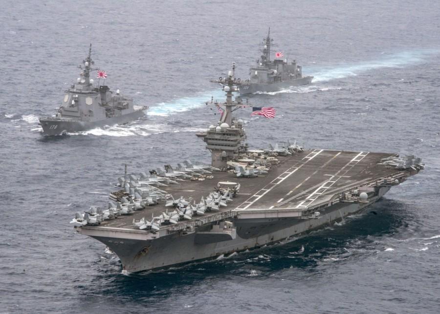 The U.S. Navy aircraft carrier USS Carl Vinson leads the Japan Maritime Self-Defense Force (JMSDF) Atago-class guided-missile destroyer JS Ashigara (L) followed by the JMSDF Murasame-class destroyer JS Samidare during a transit of the Philippine Sea April 26, 2017. The two Japanese destroyers on April 23 began an exercise with the strike group in the Western Pacific as it approaches waters around the Korean peninsula, Japan's navy said. USS Carl Vinson,Carl Vinson,USS Carl Vinson on patrol,USS Carl Vinson aircraft,Korean waters,USS Michigan,North Korean,North Korean nuclear