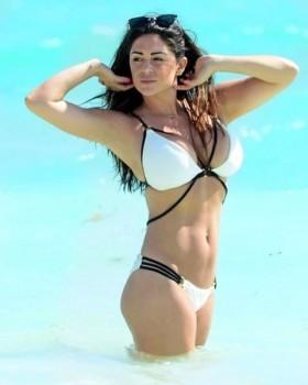 Casey Batchelor flaunts her ample assets in bikini.