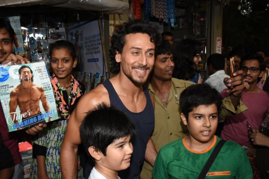 Tiger Shroff, who recently set the temperature rising with one of the hottest magazine shoots this summer was spotted yesterday at a suburban local magazine stall. The actor who was on his way to shoot for a brand campaign at Bandra's Mehboob studio, made an impromptu halt at a local magazine store to grab a copy of GQ's May issue featuring himself. Tiger Shroff,actor Tiger Shroff,Tiger Shroff at local magazine stall
