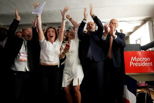 Supporters of French President-elect Emmanuel Macron react after the announcement, in Marseille.