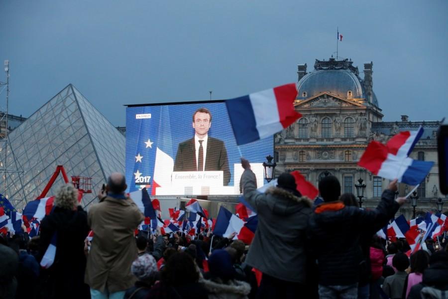 President-elect Emmanuel Macron is seen on a giant screen near the Louvre museum after results were announced. French election,Emmanuel Macron,Emmanuel Macron wins French election,Marine Le Pen,European Union