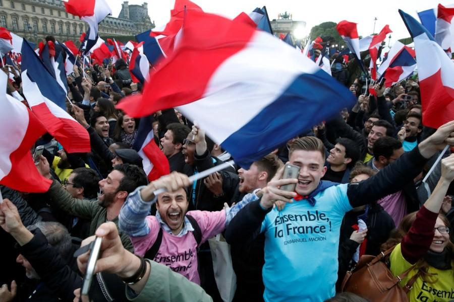 Supporters of President-elect Emmanuel Macron celebrate near the Louvre museum. French election,Emmanuel Macron,Emmanuel Macron wins French election,Marine Le Pen,European Union