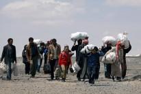 Internally displaced people who fled Raqqa city carry their belongings as they leave a camp in Ain Issa, Raqqa Governorate, Syria May 4, 2017.