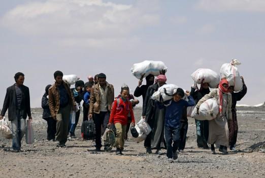 Internally displaced people who fled Raqqa city carry their belongings as they leave a camp in Ain Issa, Raqqa Governorate, Syria May 4, 2017.