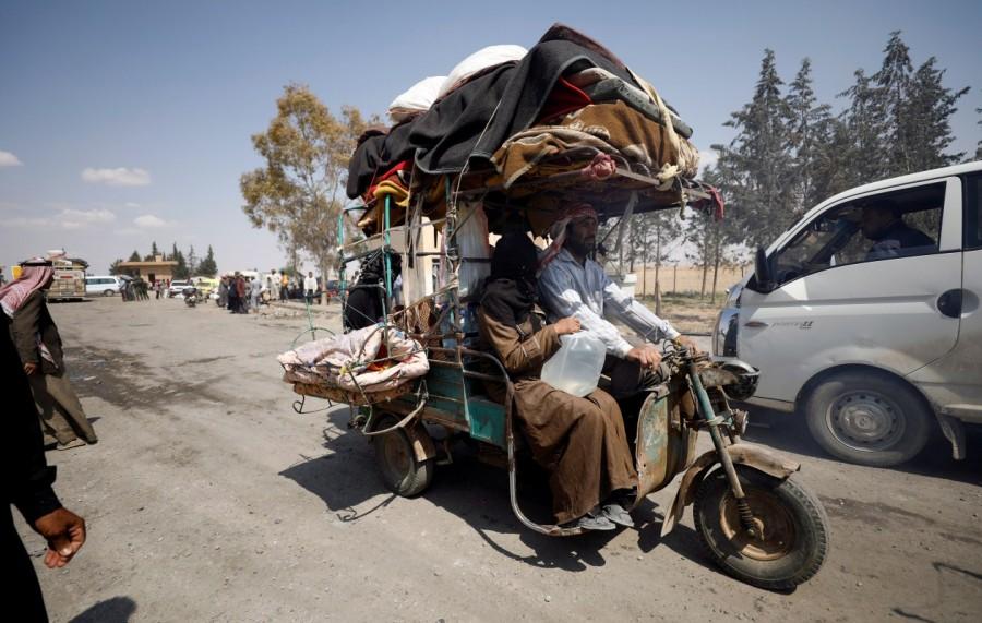 Internally displaced people who fled Raqqa city ride a tricycle with their belongings as they leave a camp in Ain Issa, Raqqa Governorate, Syria May 4, 2017. Raqqa assault,Residents flee Islamic State,Islamic State,Raqqa,Syrian Democratic Forces