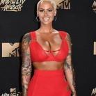 Amber Rose stuns in a plunging red dress at MTV Movie & TV Awards.