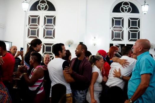 People embrace each other during a mass in a church in Matanzas. Friday was the first time a trans pastor held a Holy Communion in Cuba, highlighting how much the island nation has changed since both religious believers and homosexuals went to 