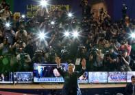 Moon Jae-in gestures to his party members as they watch a television report on a presidential election exit poll in Seoul, South Korea.