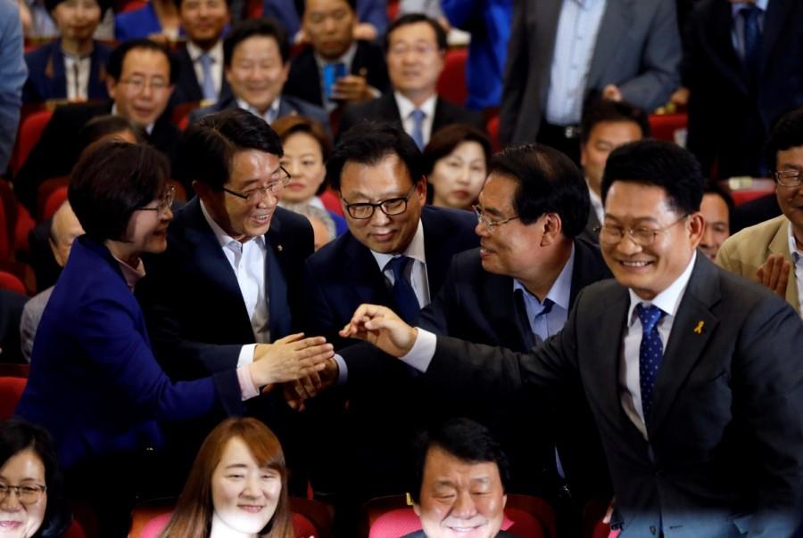 Party leaders and members of the Democratic Party of Korea react as they watch a television report in Seoul. Moon Jae-in,South Korea elects Moon Jae-in,South Korea's presidential election,North Korea,Liberal politician