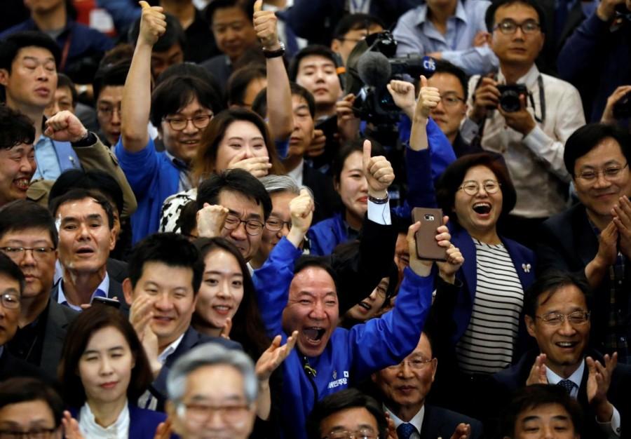 Party members of the Democratic Party of Korea react as they watch a television report in Seoul. Moon Jae-in,South Korea elects Moon Jae-in,South Korea's presidential election,North Korea,Liberal politician