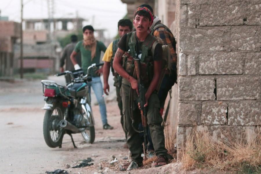 Kurdish fighters from the People's Protection Units (YPG) carry their weapons as they take positions in the northeastern city of Hasaka, Syria, August 20, 2016. Kurdish YPG fighter,Syria,NATO ally Turkey,NATO,Turkey,Kurdish YPG fighters,Syrian city,Raqqa,Islamic State