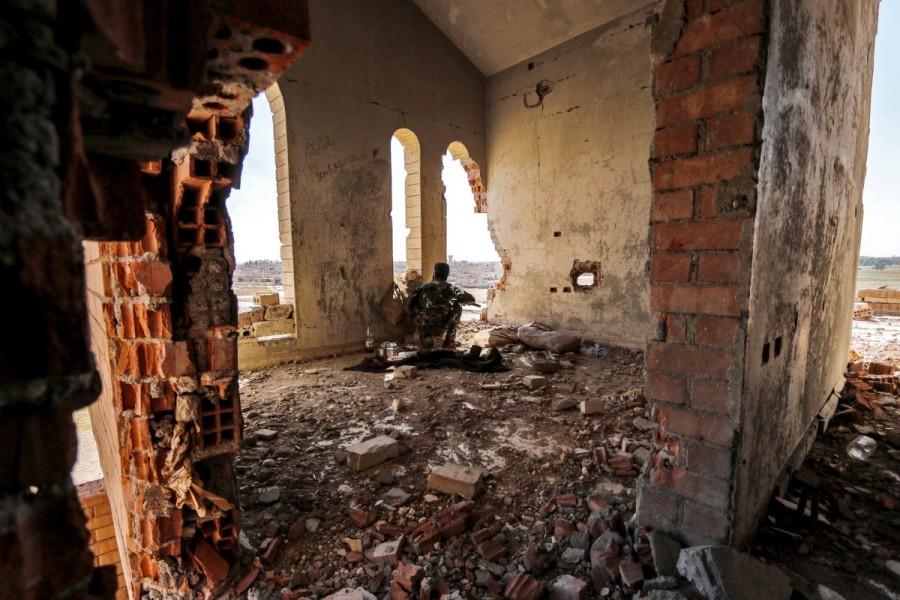 A Kurdish People's Protection Units (YPG) fighter takes up position inside a damaged building in al-Vilat al-Homor neighborhood in Hasaka city, as he monitors the movements of Islamic State fighters who are stationed in Ghwayran neighborhood in Hasaka city, Syria July 22, 2015. Kurdish YPG fighter,Syria,NATO ally Turkey,NATO,Turkey,Kurdish YPG fighters,Syrian city,Raqqa,Islamic State