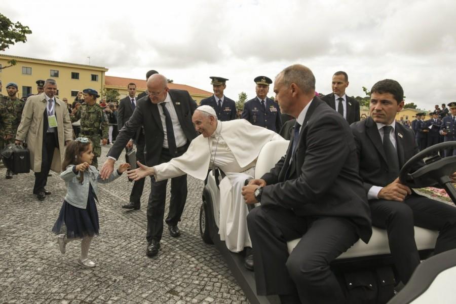 Pope Francis greets a child after visiting the chapel of Monte Real military airbase in Portugal May 12, 2017. Pope Francis will make two Portuguese shepherd children saints this week, crowning a belief that started with reported visions of the Madonna 100 years ago which have turned the Shrine of Fatima into one of the most famous in Christianity. Pope,Pope Francis,Pope Francis visits Portugal's Shrine of Fatima,Shrine of Fatima,Madonna,Our Lady of Fatima,Lady of Fatima