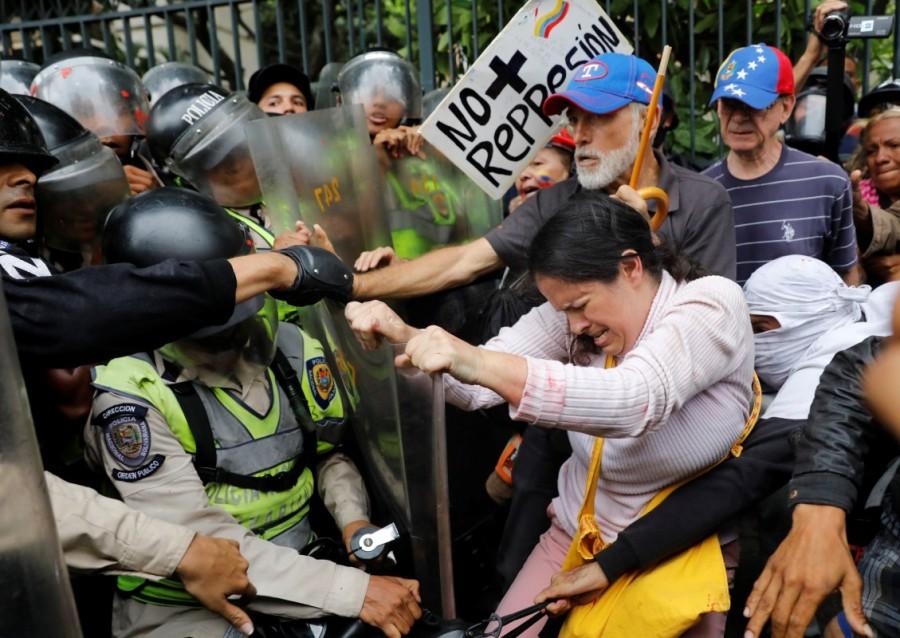 Opposition supporters confront riot security forces while rallying against President Nicolas Maduro in Caracas, Venezuela. Venezuela's elderly have been hard hit by four years of brutal recession, leading to shortages of food and medicines, long lines at shops and runaway prices. Elderly Venezuelan,Elderly Venezuelan protesters,President Nicolas Maduro,Venezuelan President Nicolas Maduro,Nicolas Maduro