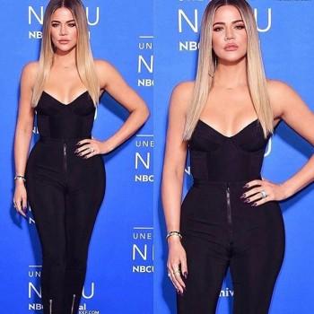Khloe and Kim Kardashian pose together in plunging outfits.