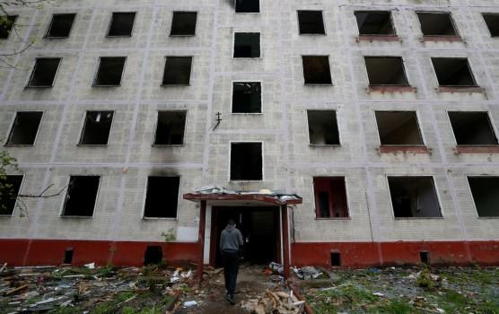 A worker passes a building, which is part of the old five-storey apartment blocks demolition project launched by the city authorities, in Moscow, Russia. The Moscow government plans to resettle millions of citizens from shoddy Soviet-era apartment blocks. The draft law on renovation envisages moving some Muscovites into modern flats but has also fuelled concerns about property rights, a year after city authorities provoked an outcry among small businesses by bulldozing many street kiosks.